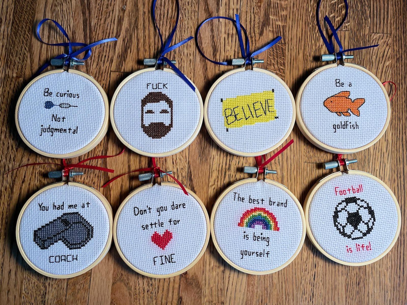 8 round cross-stitched ornaments with quotes from Ted Lasso TV show